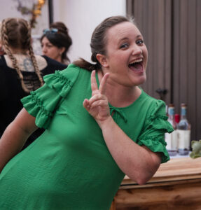 brianna communications manager in a green dress